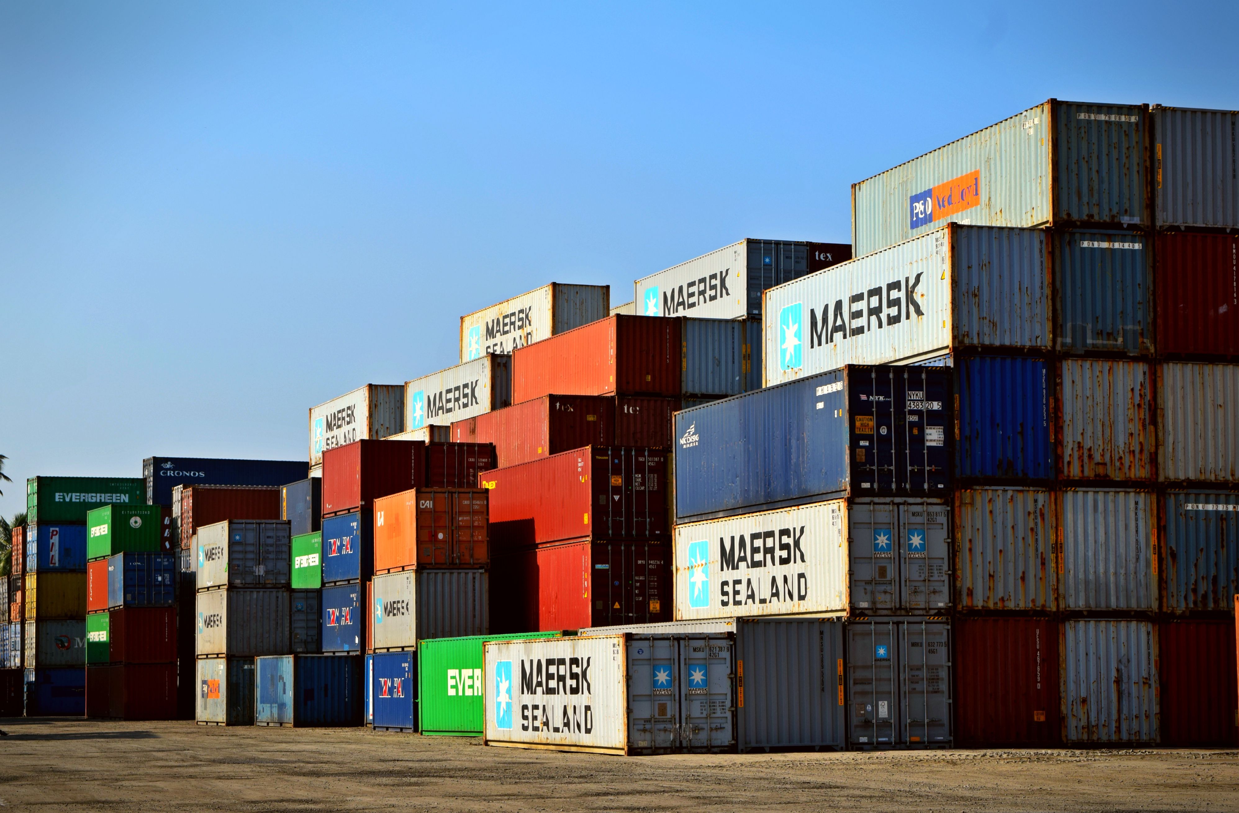 Global commercial shipping container vessel out at sea carrying freight cargo